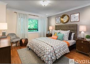 Brookline apartment for rent - A bedroom with a large bed and a chair.