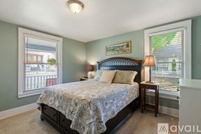 Coeur D'alene house for rent - A bedroom with a bed, nightstand, and window.