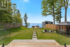 Brock house for rent - A backyard with a wooden deck and a fence.