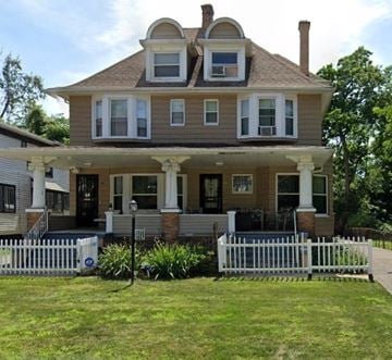 East Cleveland house for rent - A two-story house with a white picket fence in front.