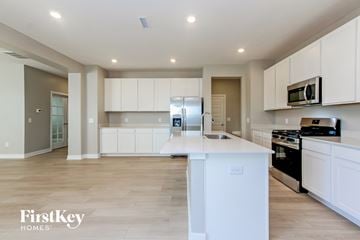 Danville house for rent - A kitchen with white cabinets and a white island.