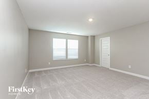 Danville house for rent - A spacious room with a carpeted floor and a window with blinds.