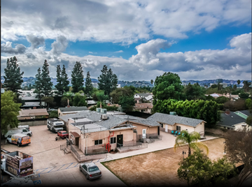 Sherman Oaks house for rent - A parking lot with cars and a building in the background.