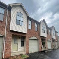 Bowling Green apartment for rent - A row of houses with garages in front.