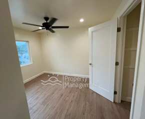 Morro Bay house for rent - A room with a ceiling fan and wooden flooring.