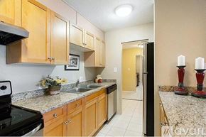 Denver condo for rent - A kitchen with wooden cabinets and granite countertops.