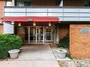 Denver condo for rent - The entrance to a building with a red awning and a glass door.