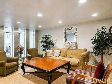 Denver condo for rent - A living room with a wooden table and a mirror on the wall.