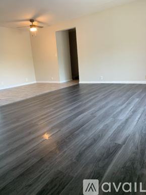 Cincinnati apartment for rent - A room with wooden flooring and a ceiling fan.