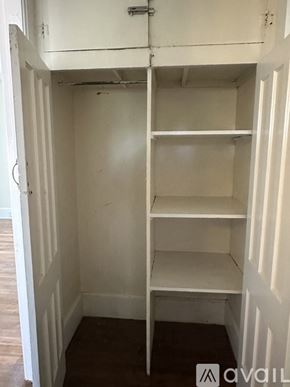 Oswego apartment for rent - A small white closet with a shelf and a door.