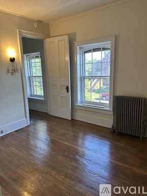 Oswego apartment for rent - A room with a wooden floor and a window.