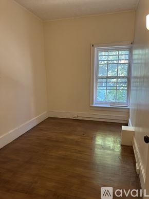 Oswego apartment for rent - A room with a window and wooden flooring.