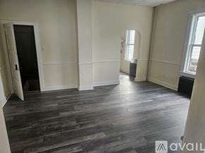 Scranton house for rent - A room with wooden flooring and white walls.