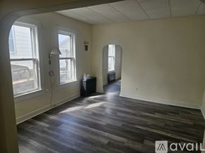 Scranton house for rent - A room with wooden flooring and two windows.