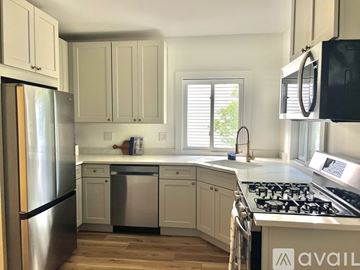 Bridgeport apartment for rent - A kitchen with a stainless steel refrigerator and a stove top oven.