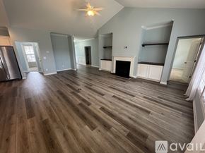 Hampstead house for rent - A spacious living room with wood flooring and a fireplace.