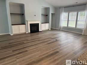 Hampstead house for rent - A living room with a fireplace and wooden floors.