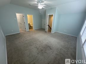 Hampstead house for rent - A spacious room with a carpeted floor and a ceiling fan.