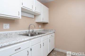 Fredericktown apartment for rent - A kitchen with white cabinets and a marble countertop.