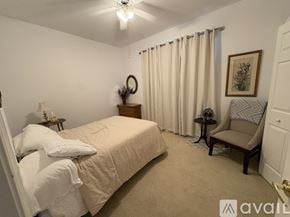 Delray Beach house for rent - A bedroom with a large bed and a chair.
