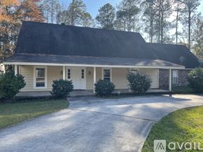 Mandeville house for rent - A house with a white door and a black roof.