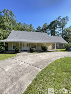 Mandeville house for rent - A house with a driveway in front of it.