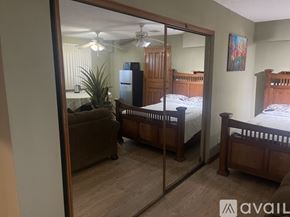 Los Angeles house for rent - A bedroom with a couch, a bed, and a dresser is shown in the image.