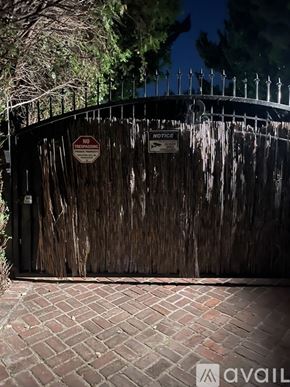 Los Angeles house for rent - A gate with a sign that says "NO TRESPASSING" is closed.