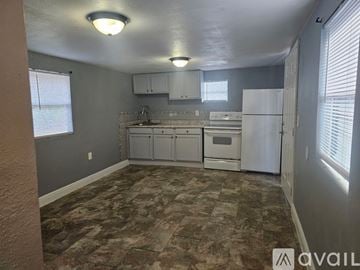 Gibsonton apartment for rent - A kitchen with a refrigerator, sink, and cabinets.