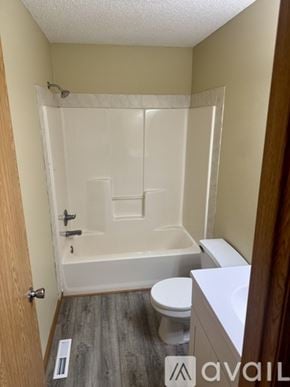 Foreston apartment for rent - A bathroom with a toilet, sink, and bathtub.