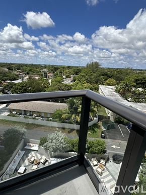 Oakland Park apartment for rent - A balcony overlooks a parking lot and a residential area.