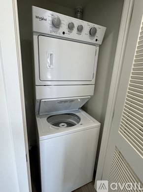 Oakland Park apartment for rent - A white Whirlpool dishwasher and washing machine are stacked in a small space.