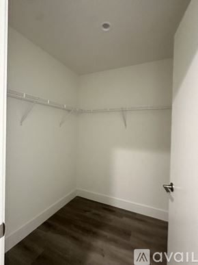 Oakland Park apartment for rent - A small, empty room with a door on the right and a wall-mounted coat rack.