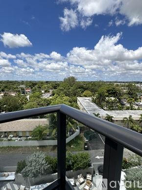 Oakland Park apartment for rent - A balcony overlooks a residential area with houses and trees.