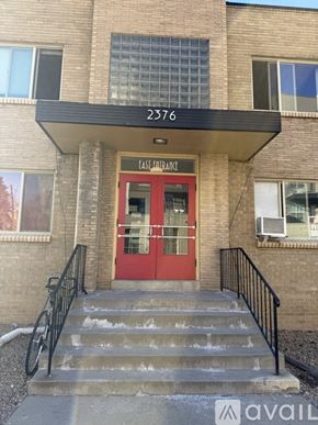 Denver apartment for rent - A room with wooden flooring and a window with blinds.