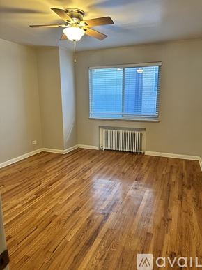 Denver apartment for rent - A room with wooden flooring and a ceiling fan.