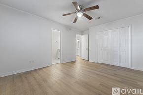 Pace apartment for rent - A spacious room with a ceiling fan and wooden flooring.