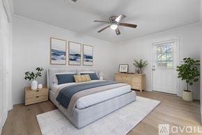Pace apartment for rent - A bedroom with a large bed, a ceiling fan, and a painting on the wall.