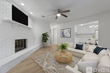 Pace apartment for rent - A living room with a white couch and a fireplace.