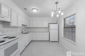 Pace apartment for rent - A kitchen with white cabinets and appliances.