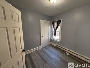 Taunton apartment for rent - A room with a door, a window with curtains, and a wooden floor.