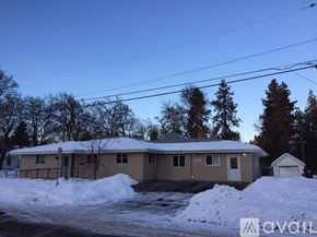 Cheney apartment for rent - A house with a snow-covered ground in front of it.