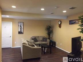 Cheney apartment for rent - A living room with a couch, a coffee table, and a television.