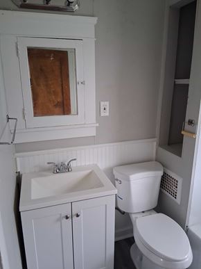 Cleveland apartment for rent - A white toilet sits next to a sink in a small bathroom.