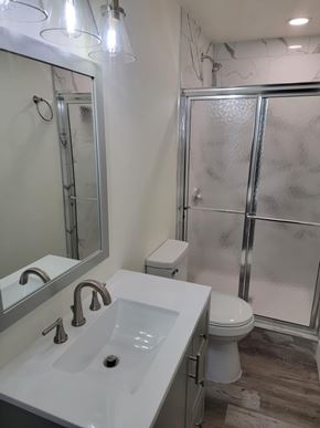 Herriman house for rent - A white sink with a silver faucet is in front of a mirror in a bathroom.