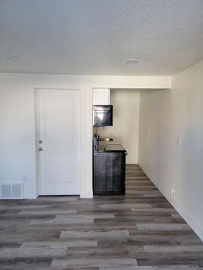 Herriman house for rent - A room with a white door and a wooden cabinet.
