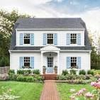 Brooklyn apartment for rent - A white house with blue shutters and a wooden walkway leading to the front door.