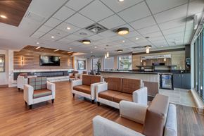 Leduc apartment for rent - A spacious waiting area with brown and white furniture.