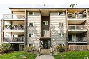 Edmonton apartment for rent - A large apartment building with a green lawn in front.