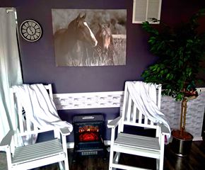 Riverside apartment for rent - Two white chairs are in front of a purple wall with a framed picture of a horse.